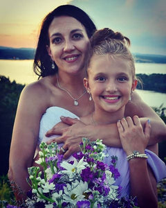 Bride wearing Teardrop CZ necklace on her wedding day with junior bridesmaid