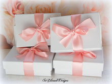 Wrapped gift boxes for bridesmaids of their teardrop earrings 