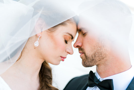 Bride wearing long CZ earrings for wedding