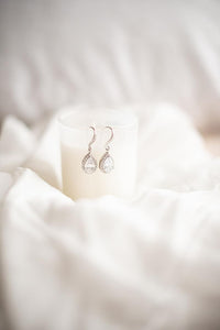 Bridal earrings dispalyed on candle holder