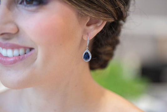 Bride wearing sapphire blue drop earrings