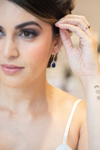 bride wearing sapphire blue earrings