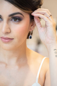 bride wearing sapphire blue earrings