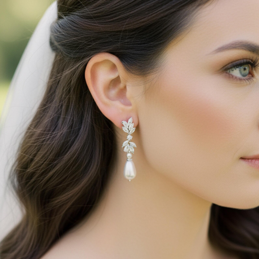 Close-up of a woman wearing elegant Pearl Drop CZ earrings with a blurred background