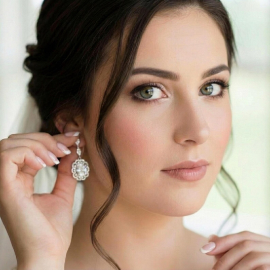 Bride wearing a decorative vintage glamour earrings with a soft focus background