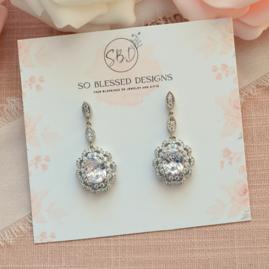Pair of silver Art Deco Statement earrings on a 'So Blessed Designs' card with floral background