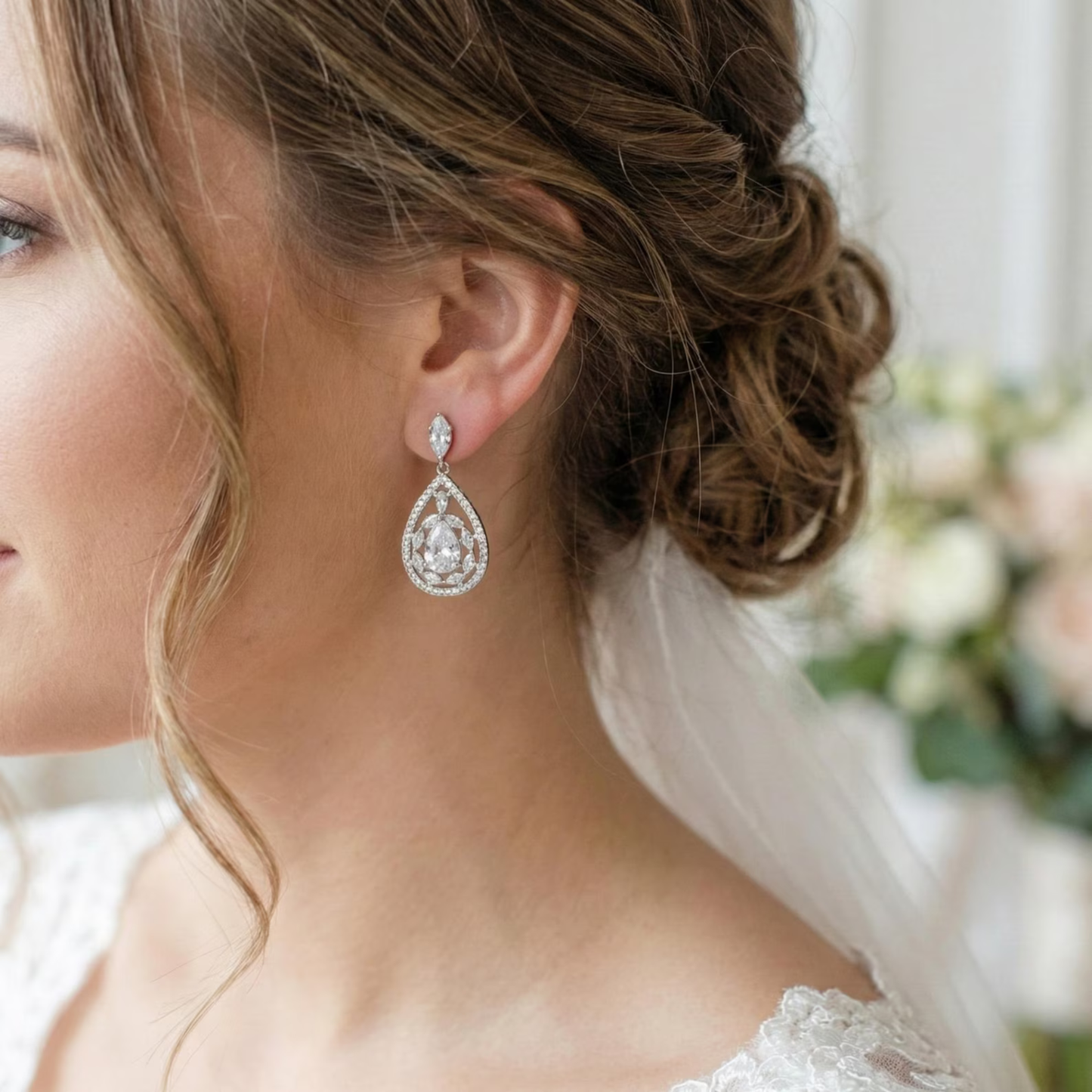 Close-up of a bride wearing a Cubic Zirconia diamond earrings with a blurred background