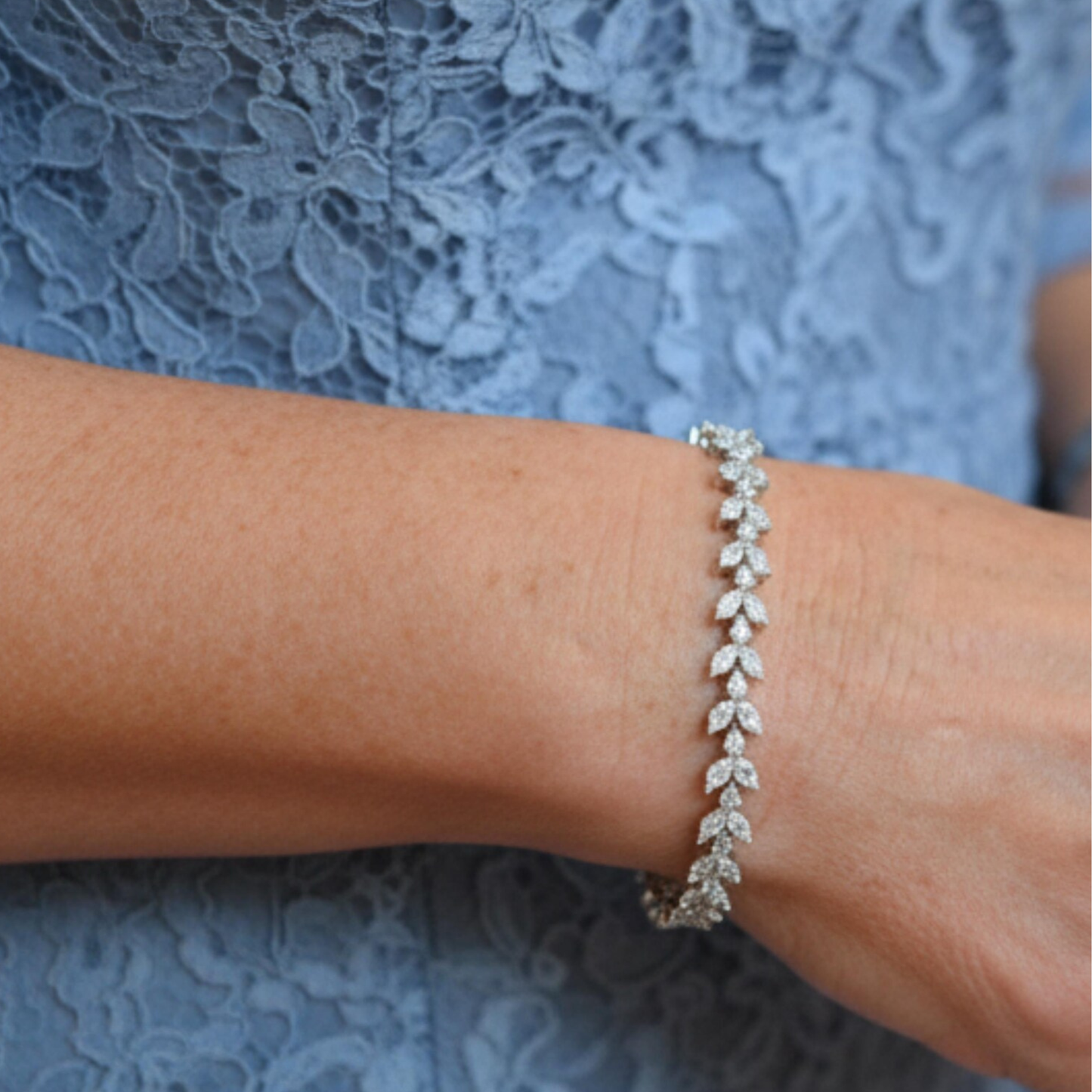 Close-up of silver and CZ mother of the groom bracelet on wrist