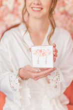 bride showing her wedding earrings in gift box