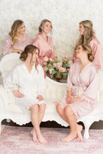 Bride surrounded by her bridesmaids in their pearl and silver earrings