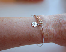 lady wearing compass bracelet on wrist