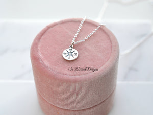 Close up of compass necklace sterling silver