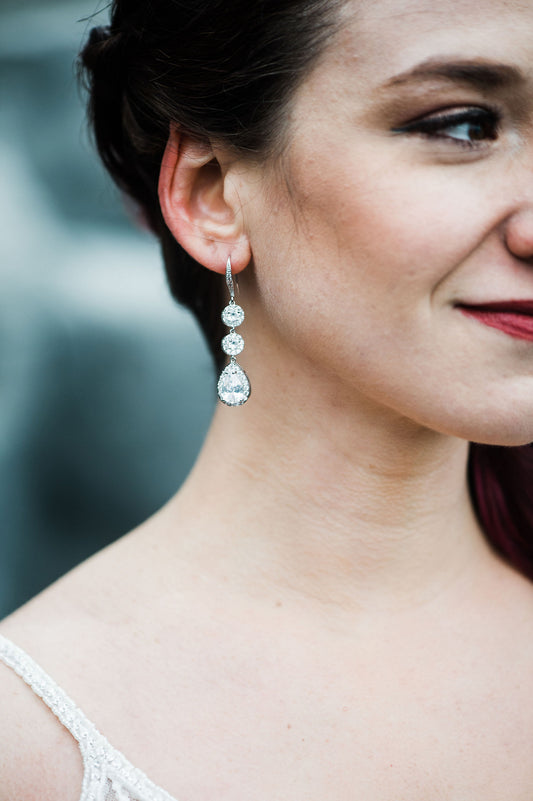 Beautiful bride wearing long crystal earrings