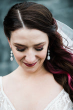 Bride wearing long crystal earrings on her wedding day