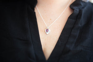 New mom wearing baby footprints necklace 