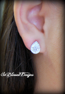 Girl wearing pair of silver teardrop earrings