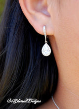 bridesmaid wearing silver teardrop earrings 
