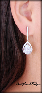 Silver long teardrop earrings worn by bride