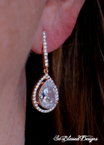 rose gold long earrings proudly worn by bride