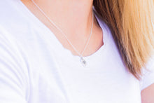 Bridesmaid wearing silver delicate compass necklace