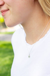 Girl wearing silver compass necklace