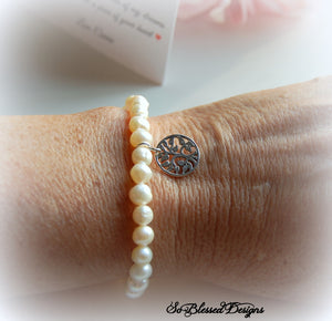 Mother of the Groom wearing pearl bracelet from bride