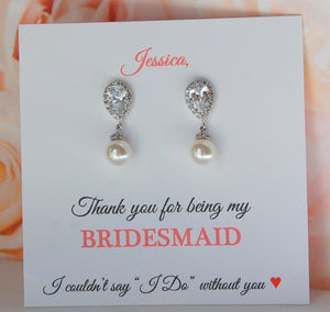 Pearl drop bridesmaid earrings displayed on personalized thank you for being my bridesmaid card
