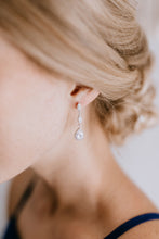 bridesmaid wearing gorgeous silver drop earrings