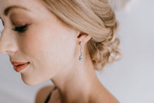 Bridesmaid wearing long elegant teardrop earrings