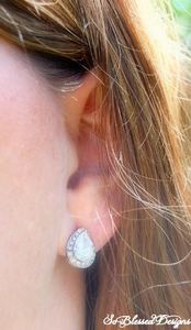 Bridesmaid wearing pair of silver teardrop earrings 