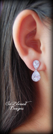 Bride wearing double teardrop earrings with dress
