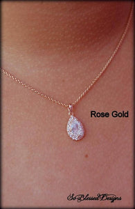 rose gold teardrop pendant worn by mother of groom