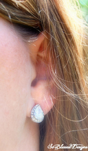 Close up of silver teardrop earrings for mother of bride
