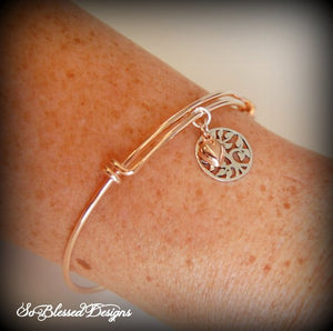 close up of lady wearing rose gold family tree bracelet on wrist