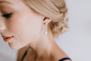 bridesmaid wearing long delicate silver and crystal earrings