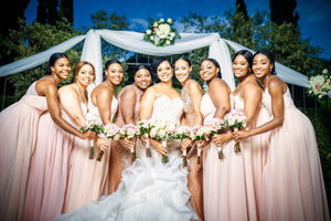 Bride with her bridesmaids wearing rose gold earrings 