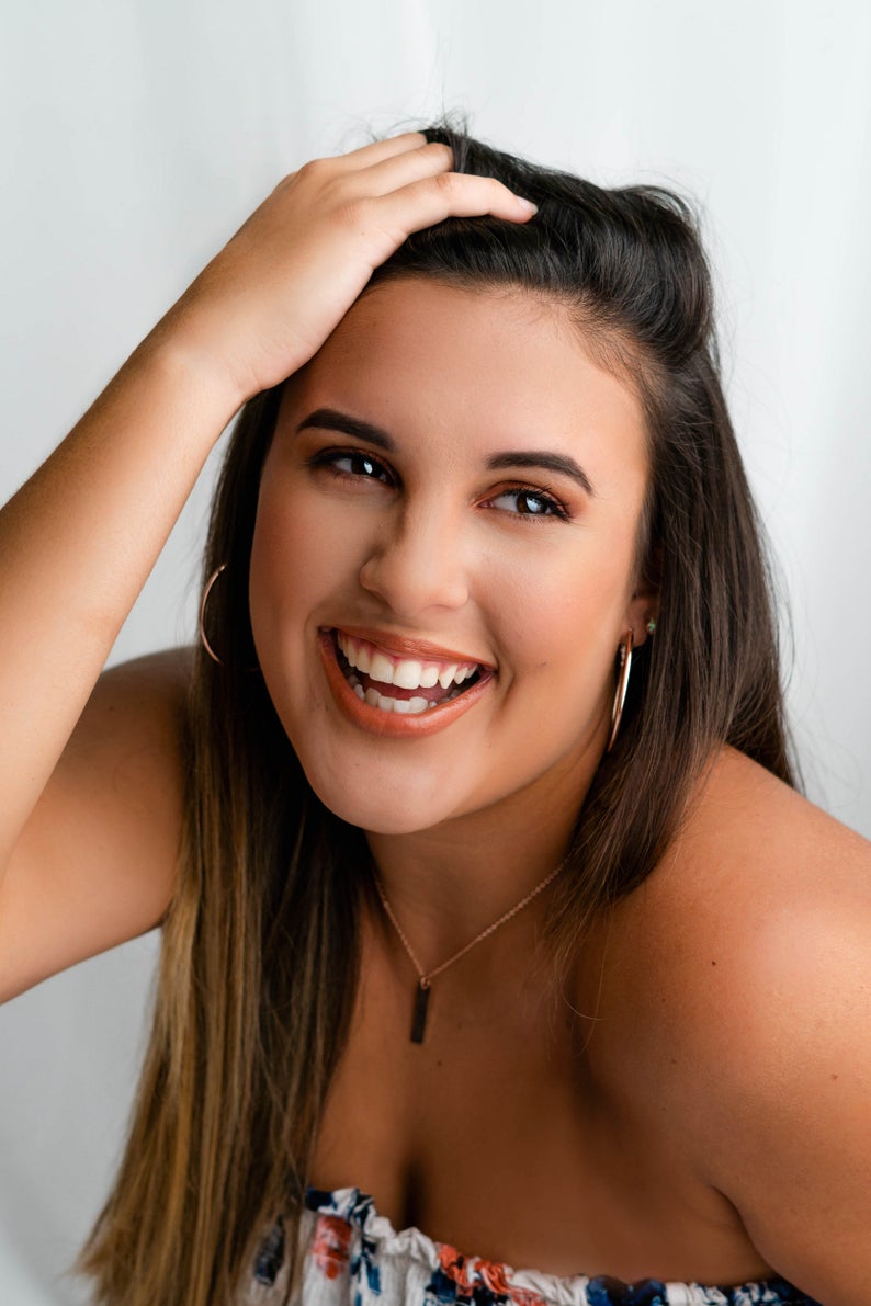 Model wearing initial rose gold jewelry