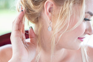 Bride wearing crystal teardrop wedding earrings
