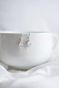 Crystal and sterling silver bridal earrings hanging on display
