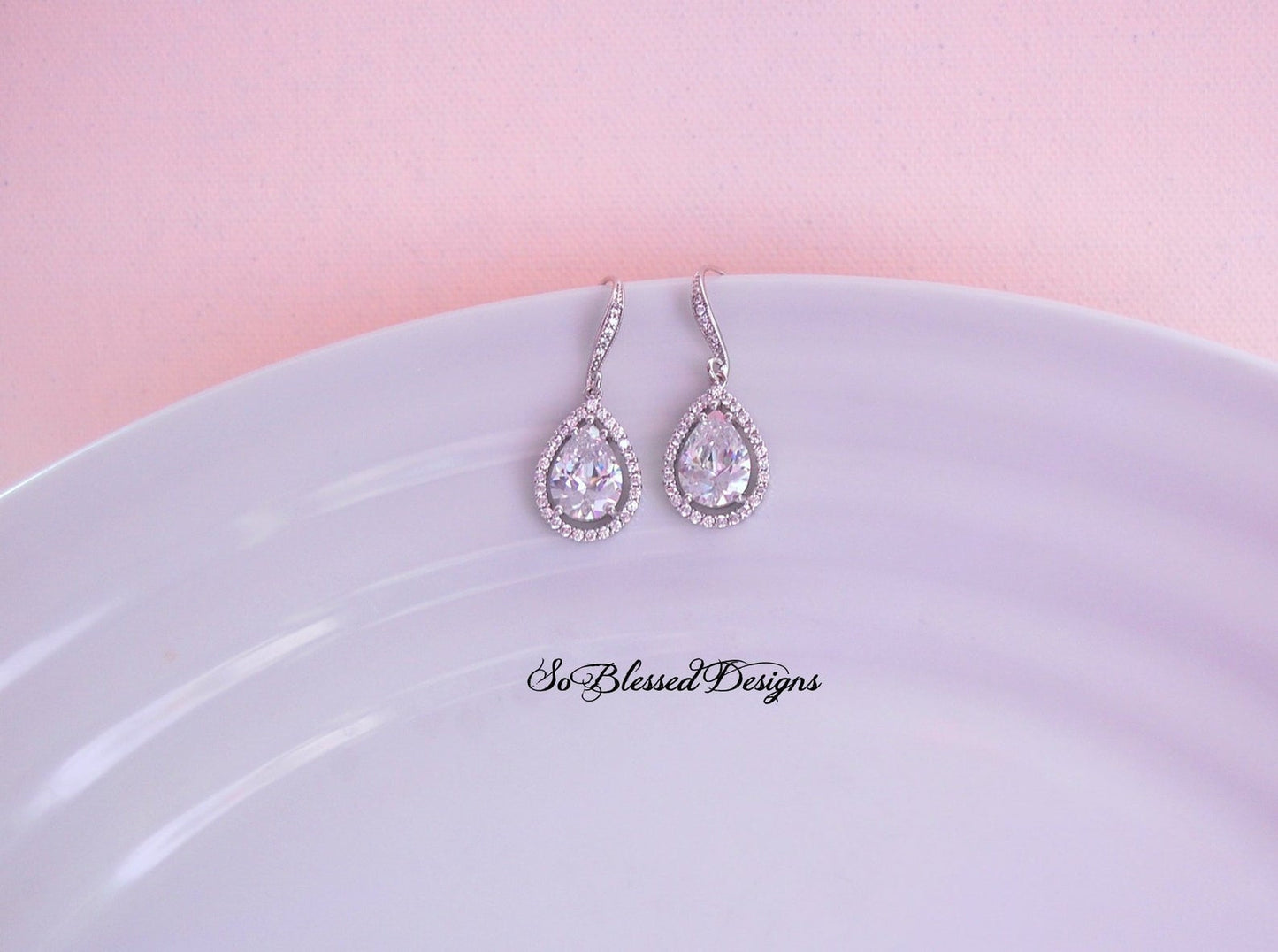 silver and crystal teardrop earrings on display