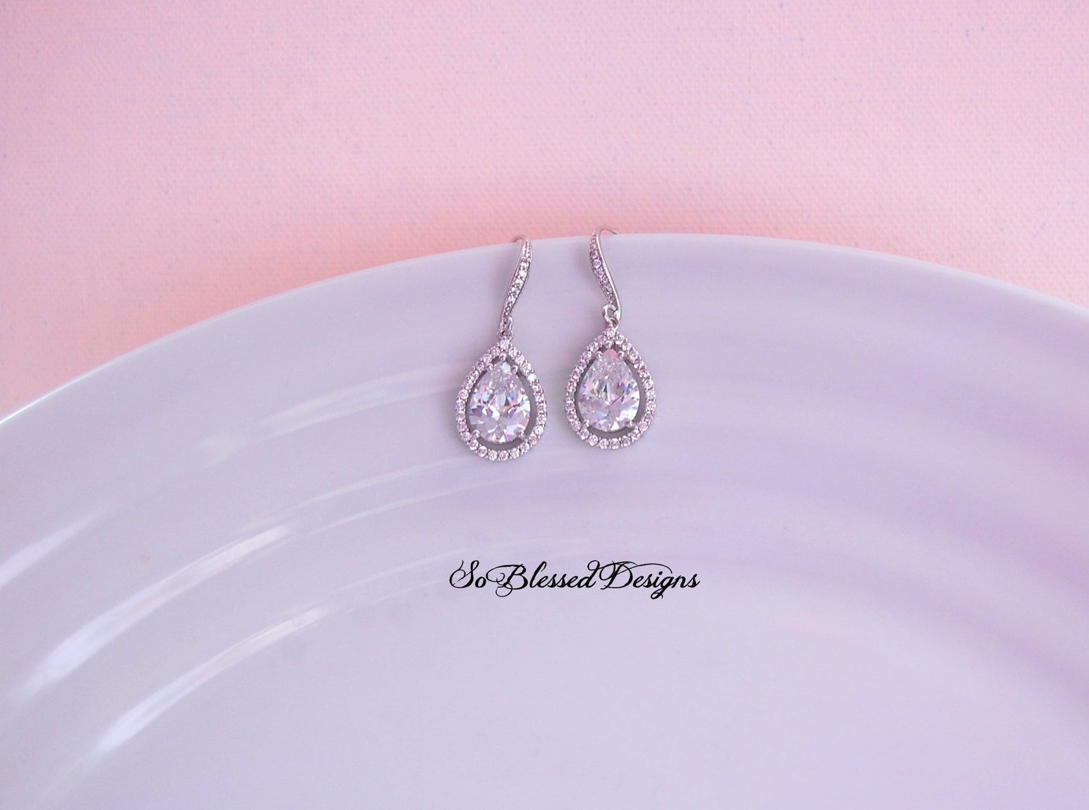 silver and crystal teardrop earrings on display