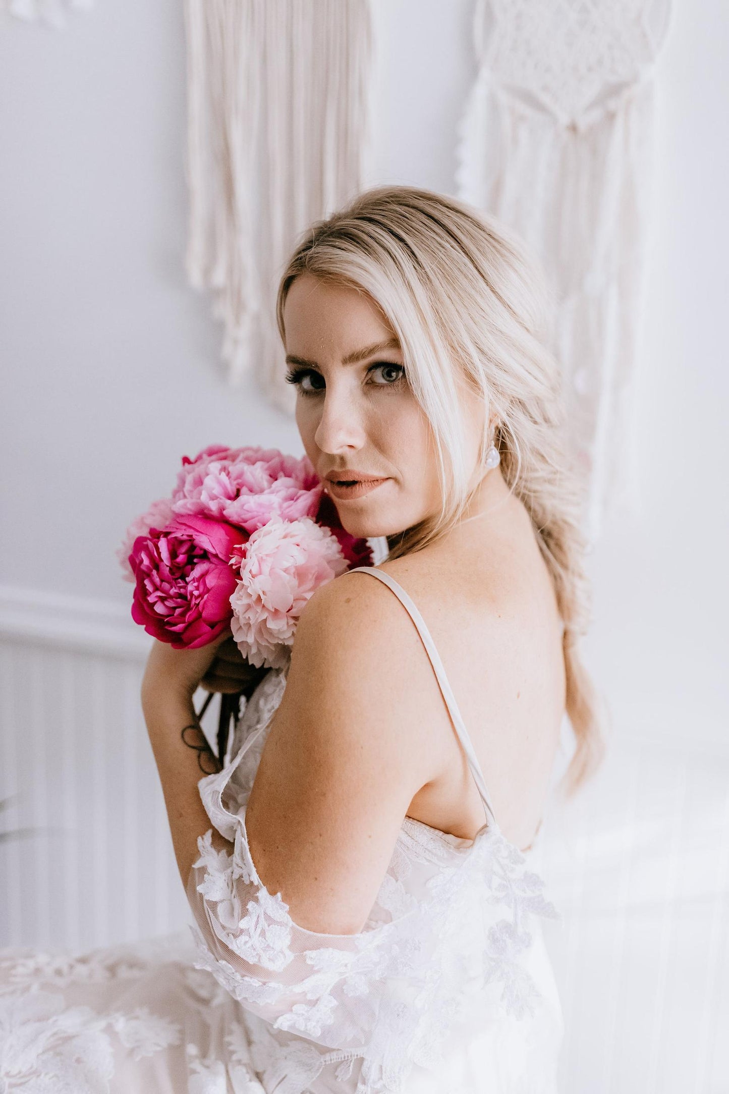 bride modeling silver teardrop wedding earrings