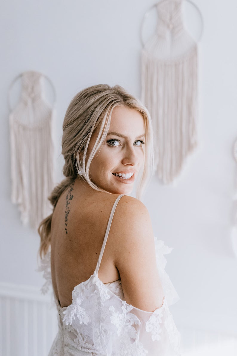 bride showing her wedding earrings teardrop style