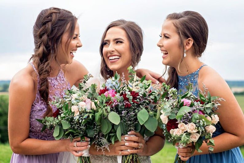 bridal party with silver pear shaped earrings on wedding day