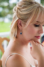 Bride wearing navy blue earrings as something blue on wedding day