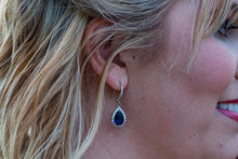 bridesmaid with silver and navy blue earrings on