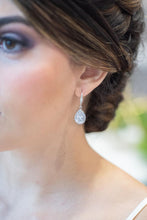 Bride showing off bridal earrings