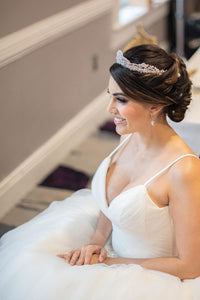 Bride modeling silver wedding earrings
