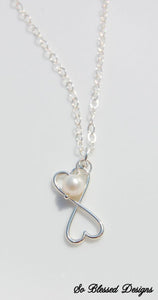Two joined hearts in silver with freshwater pearl in the middle necklace