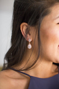 mother of the groom showing her rose gold wedding earrings